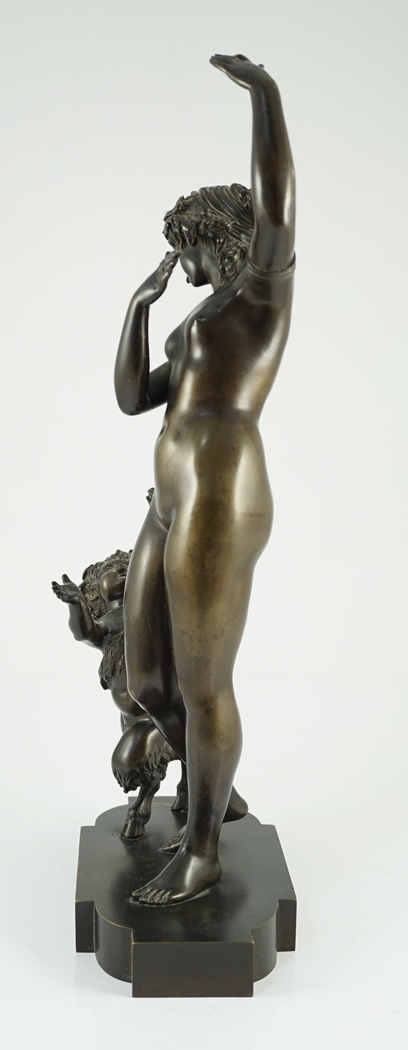 A 19th century French bronze group of a muse dancing alongside a faun, 24cm wide, 52cm high